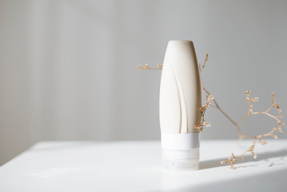Elegant minimalist skincare bottle with dried branch, ideal for beauty and spa themes.