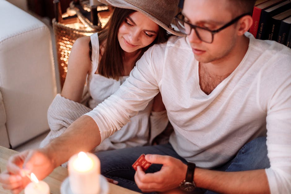 A couple enjoys a romantic candlelit moment together indoors, creating a warm and cozy atmosphere.