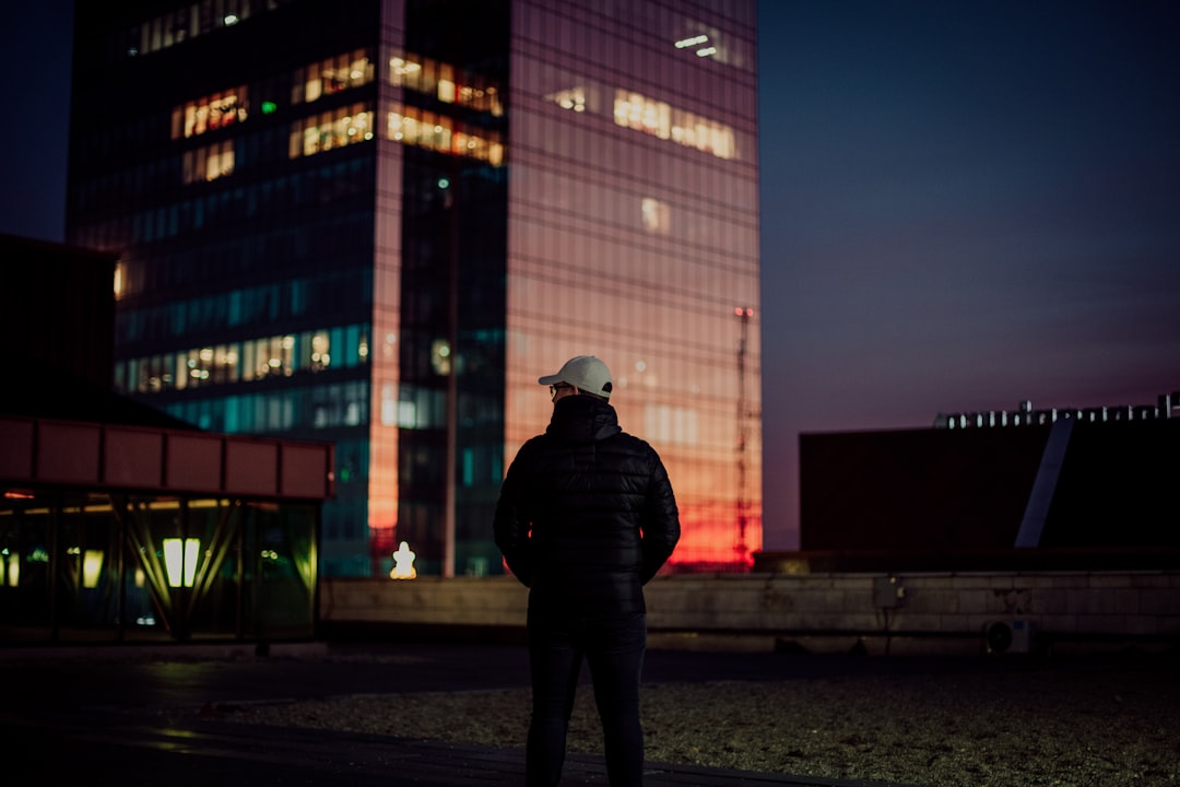 a man standing in front of a tall building