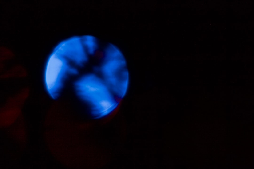 A glowing blue orb against a dark background.