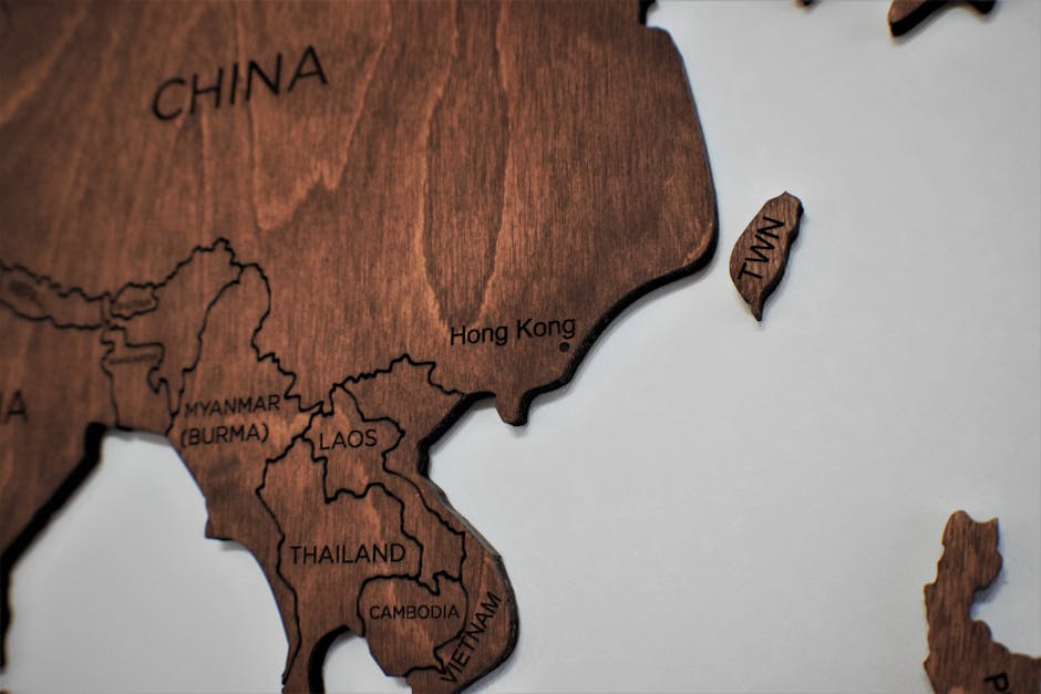 Detailed wooden map art showcasing countries in Asia with carved region names.