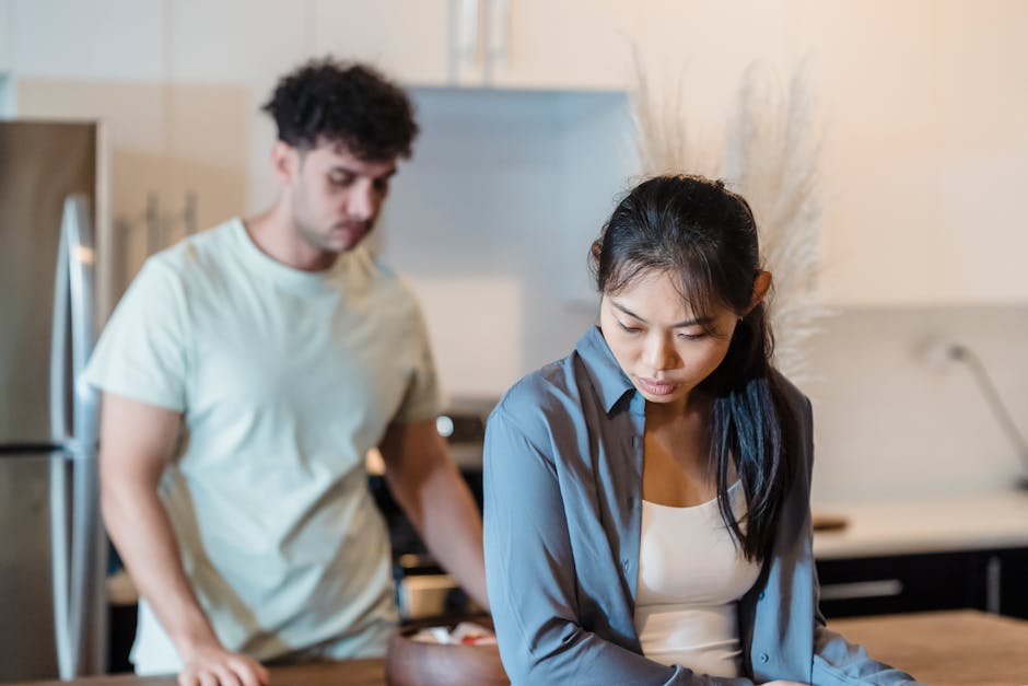 A couple having a serious conversation in a modern kitchen setting.