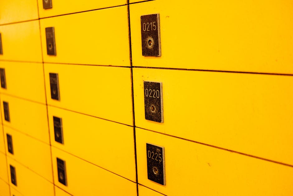 Close-up view of yellow lockers with numbered plaques, ideal for storage or security themes.