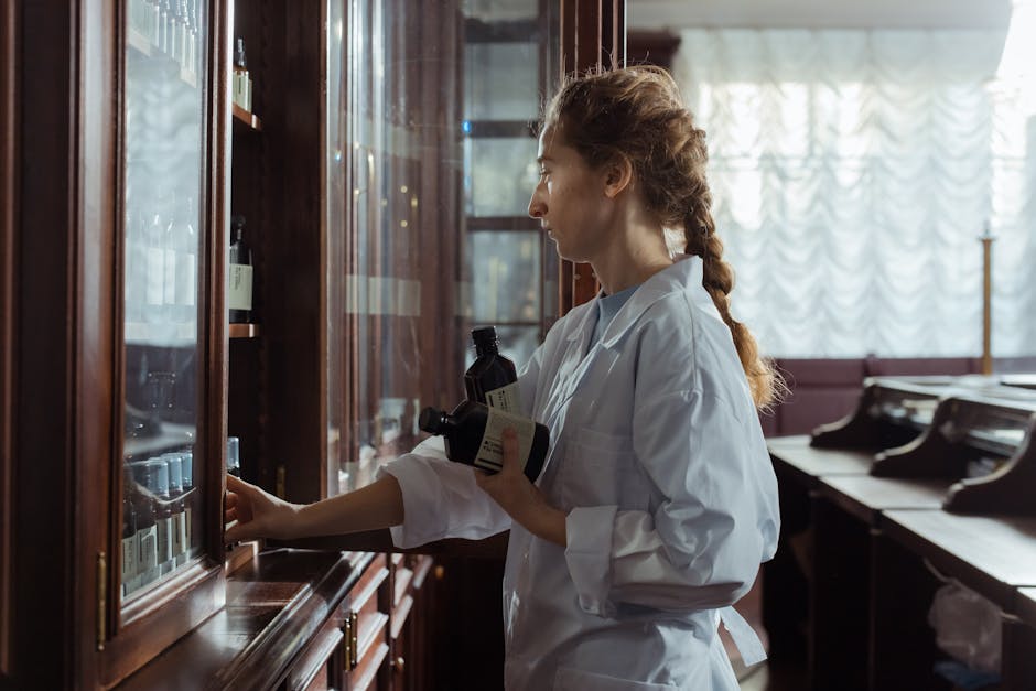 A female pharmacist arranging bottles in a classic pharmacy interior, captured indoors.