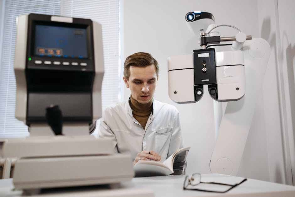 An optometrist studies a manual next to eye examination equipment in a clinic.