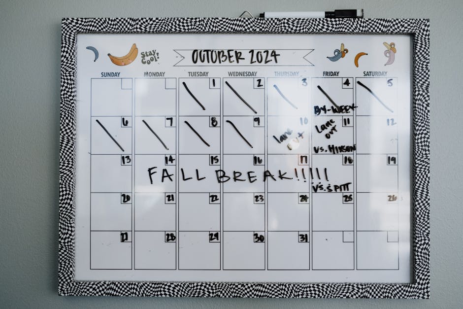 Close-up of a whiteboard calendar for October 2024 featuring a fall break note.