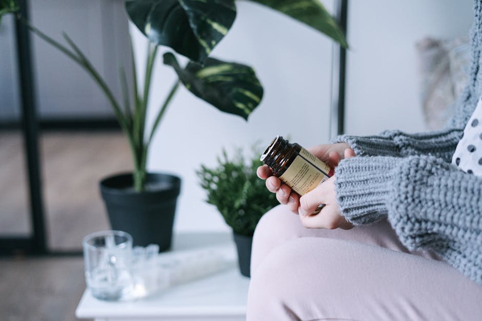 A woman in a sweater holding a medicine bottle indoors, surrounded by plants.