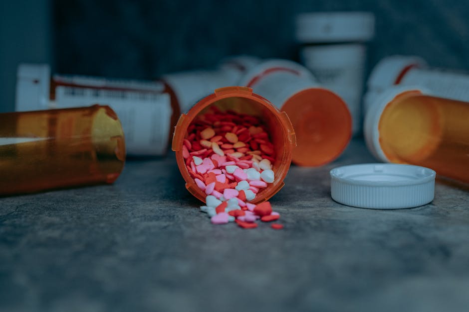Colorful pills spilling from a prescription bottle on a counter in Portland, OR.